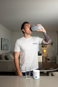 a man drinking water from a plastic cup
