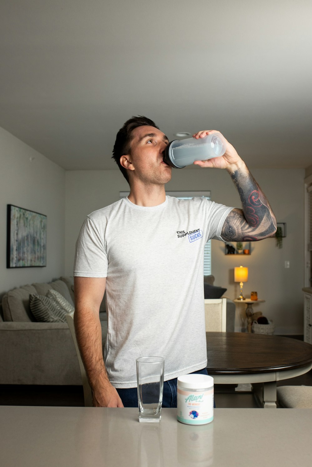 a man drinking water from a plastic cup