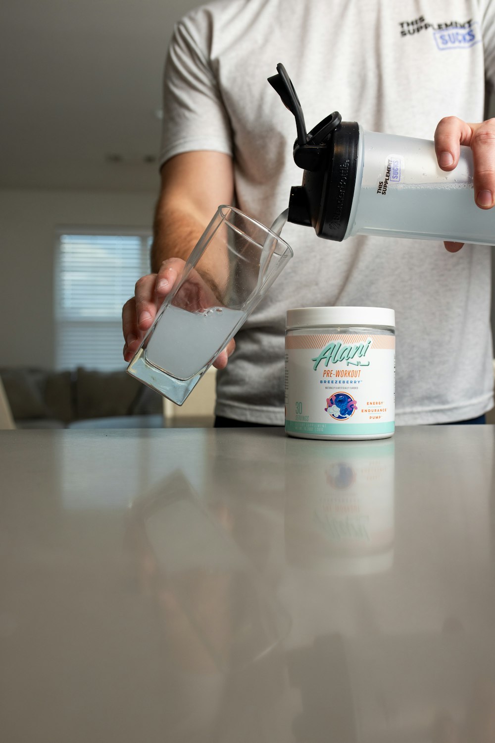 a man pouring a drink into a glass