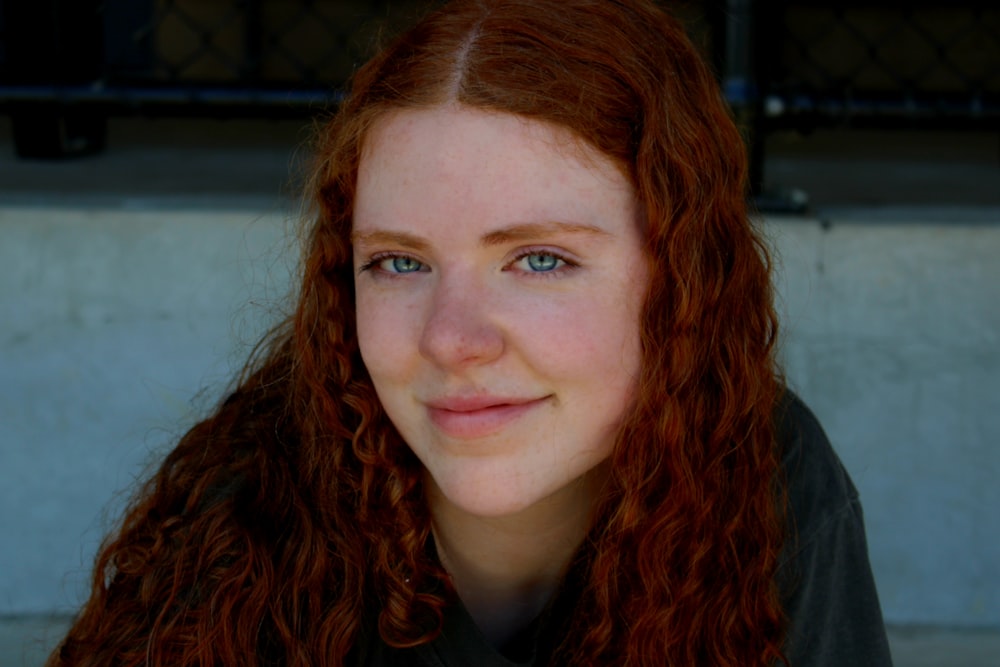 a close up of a person with red hair