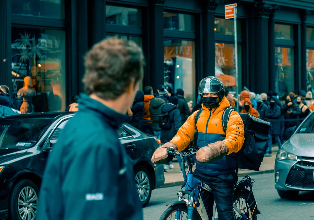 a man riding a bike down a busy street