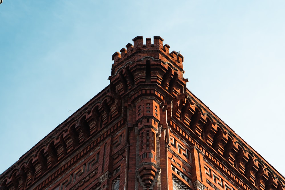 a very tall brick building with a clock on it's side