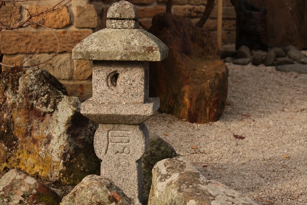a stone lantern sitting on top of a pile of rocks