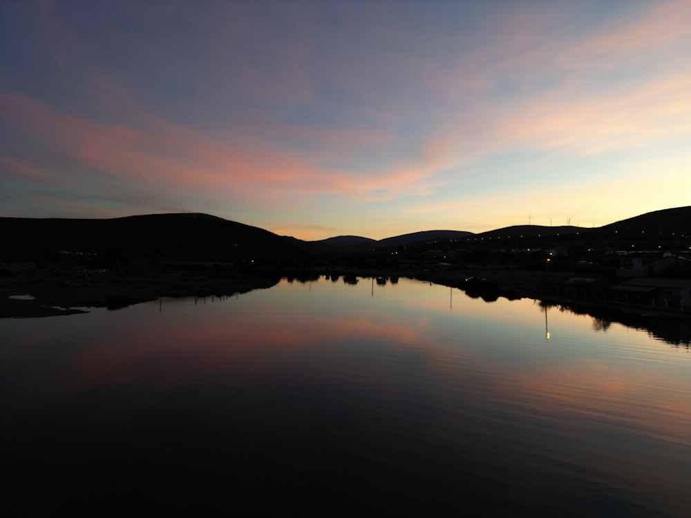 a body of water with mountains in the background