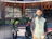 Friendly small business owner standing proudly in front of his shop.