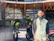 Friendly small business owner standing proudly in front of his shop.