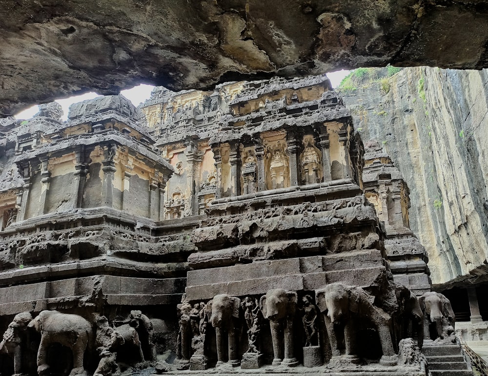 a group of elephants standing in front of a building