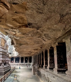 a cave like structure with a long walkway between two buildings