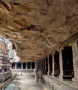 a cave like structure with a long walkway between two buildings