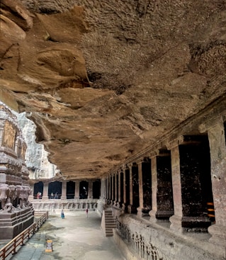 a cave like structure with a long walkway between two buildings