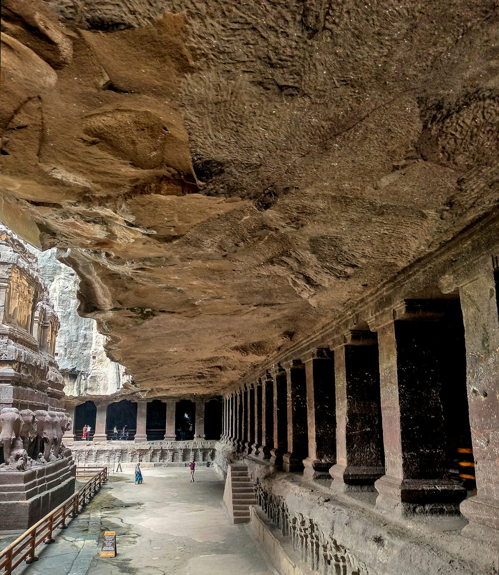 a cave like structure with a long walkway between two buildings