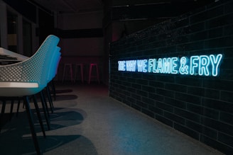 Stylish seating area inside a modern venue with neon accents that match the energy of our food truck vibe.