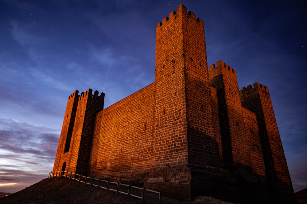 a tall brick building sitting on top of a hill