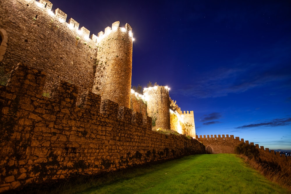 a castle with a grassy field in front of it