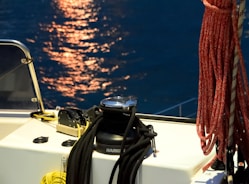 a close up of a boat's steering wheel on a body of water
