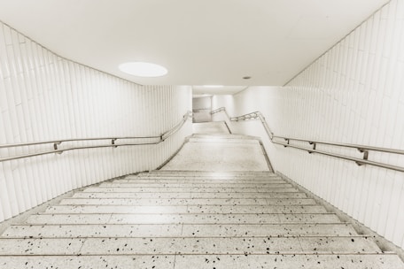 A sleek metal staircase with a modern design in a well-lit indoor setting.