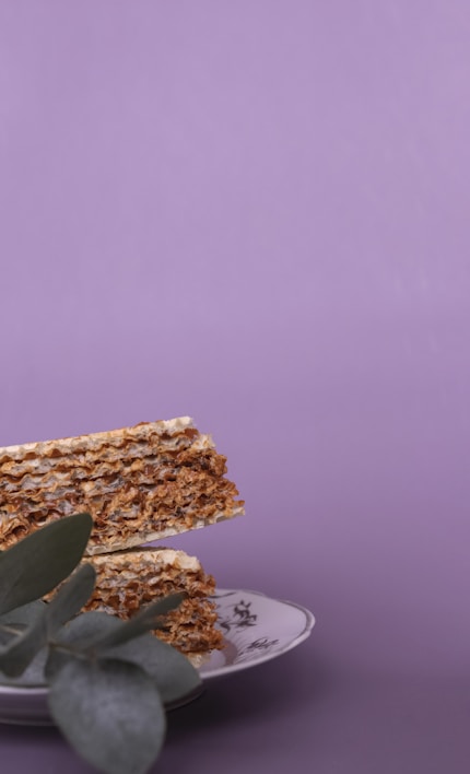 Close-up of crispy amaranth wafers stacked on a rustic wooden table.