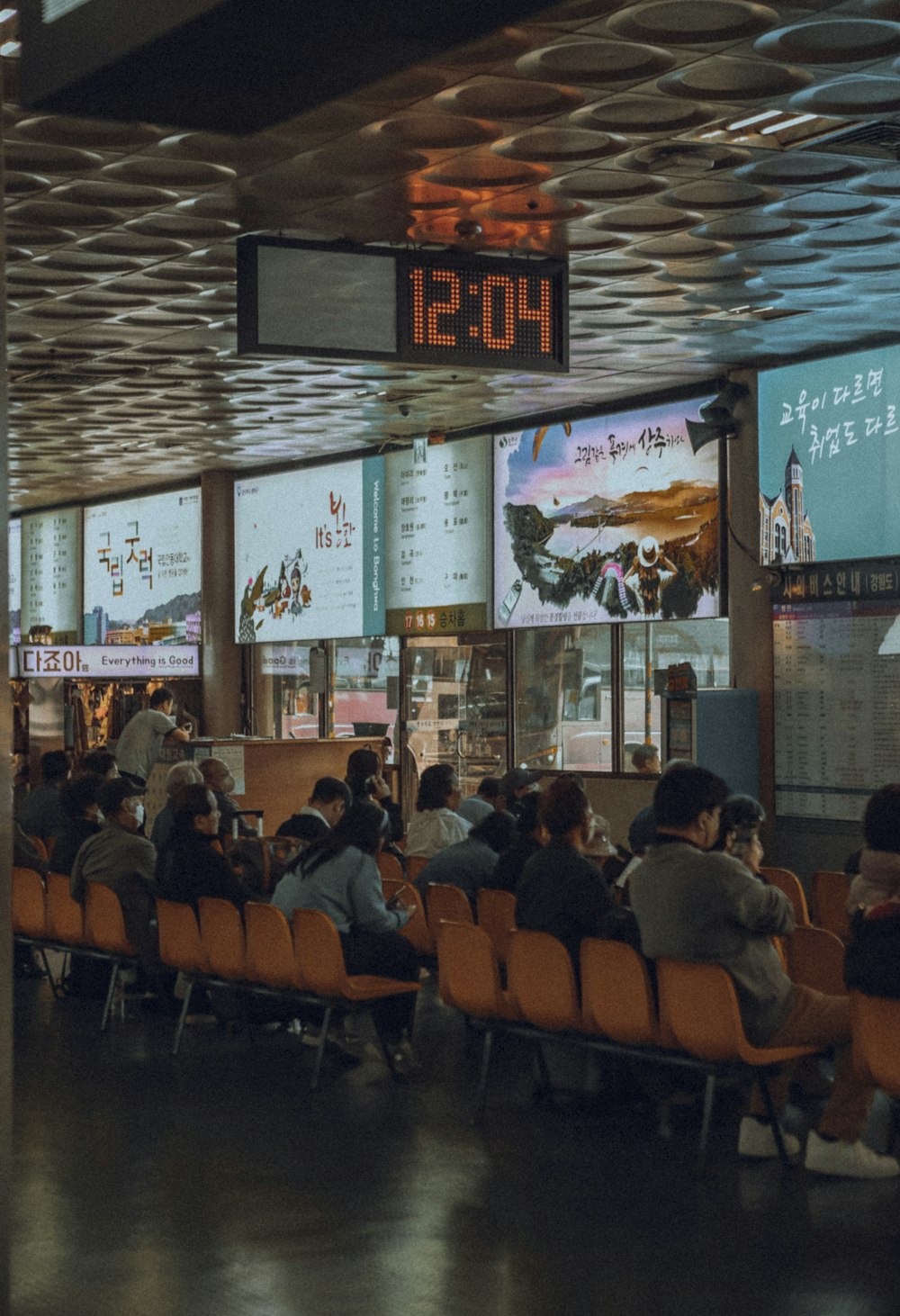 a group of people sitting in a waiting area