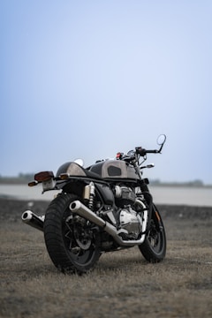 A mechanic adjusting the carburetor of a classic motorcycle