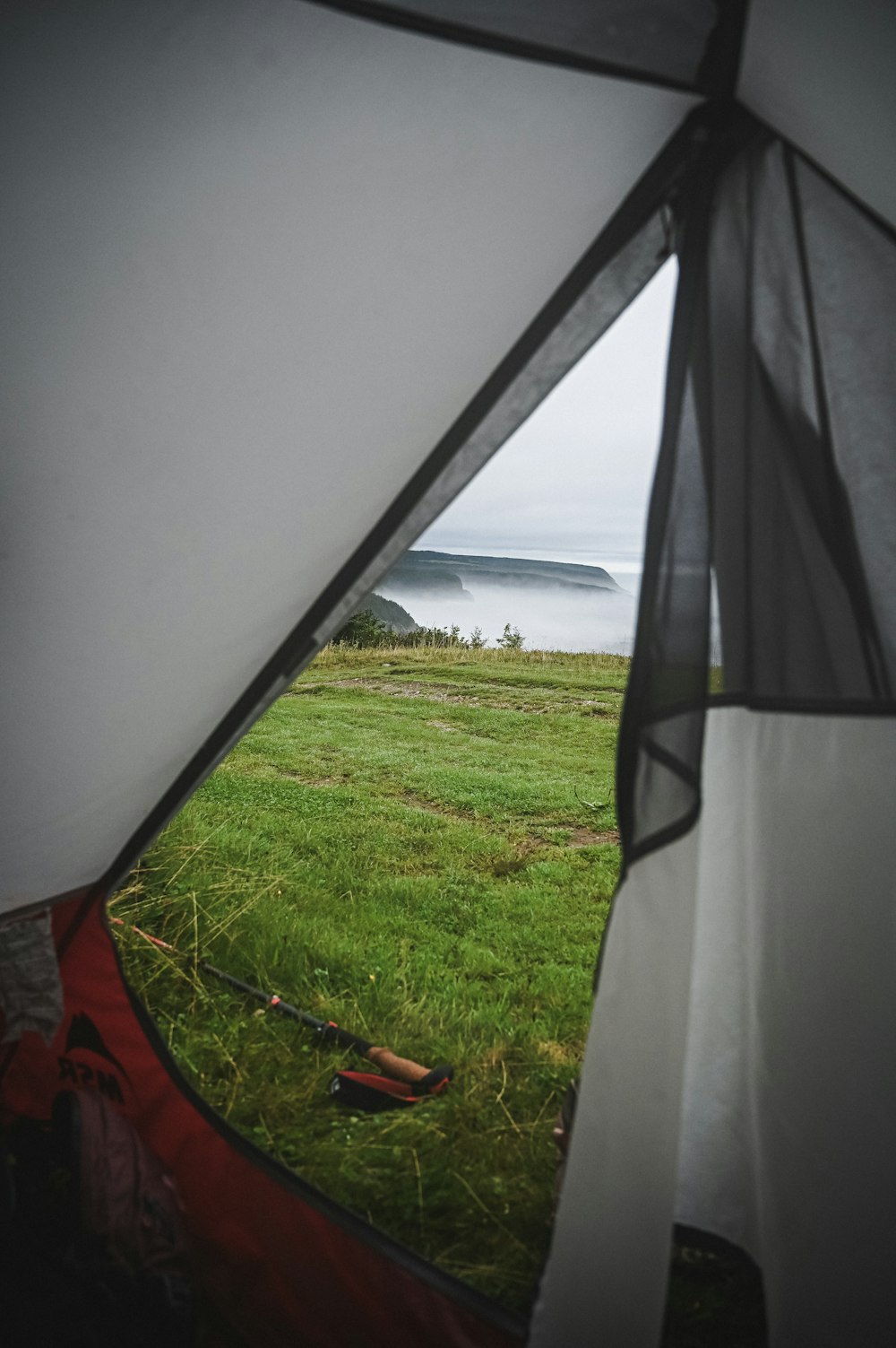 a view of the ocean from inside a tent