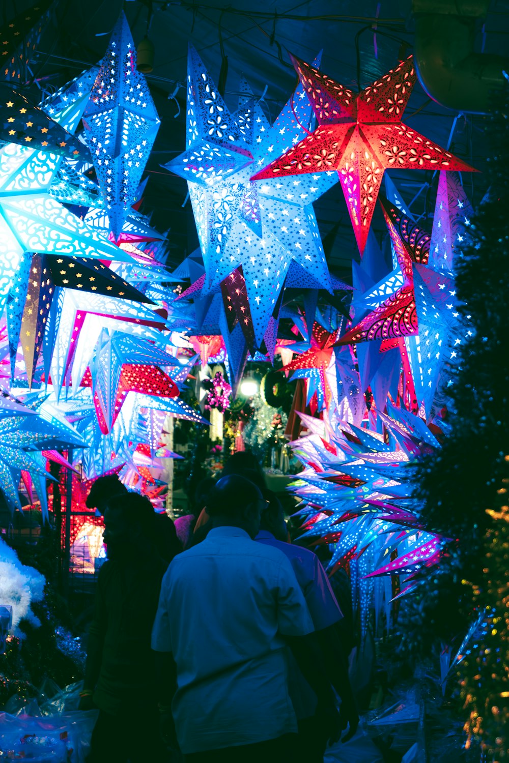 a group of people looking at christmas lights