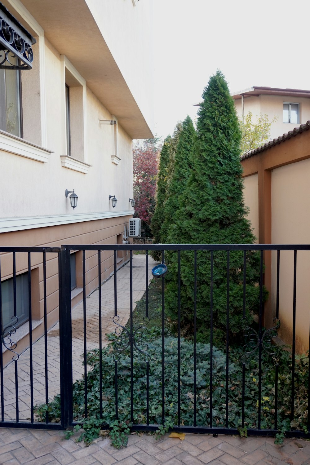 a black metal fence next to a building