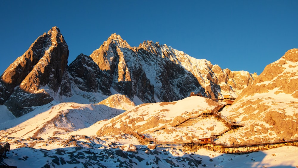 a train traveling through a snow covered mountain range