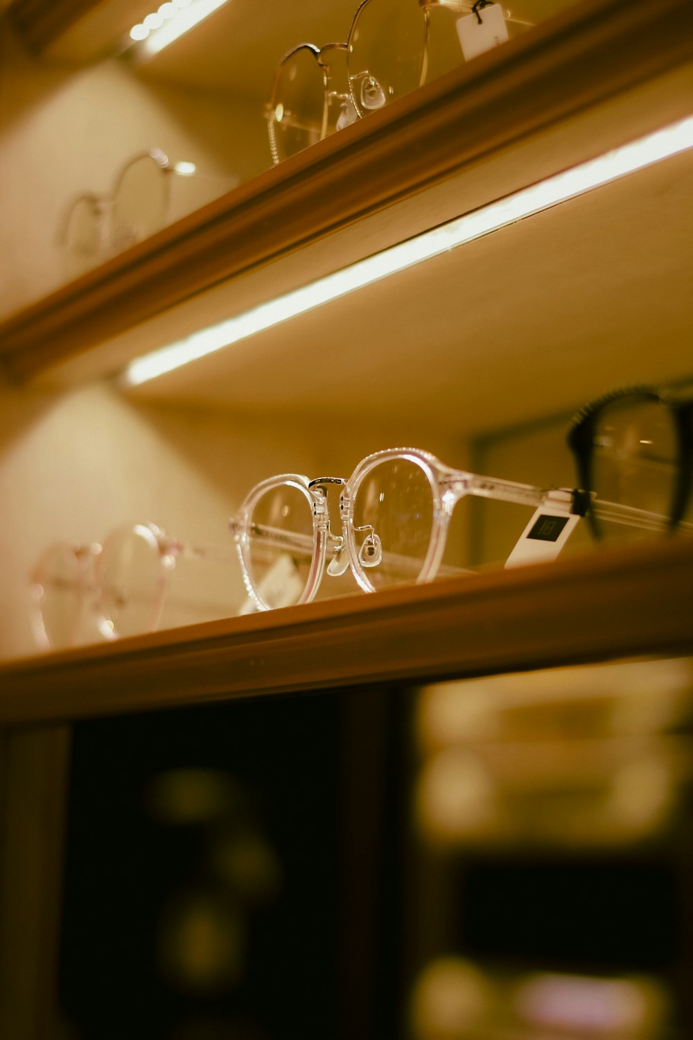 a pair of glasses sitting on top of a shelf