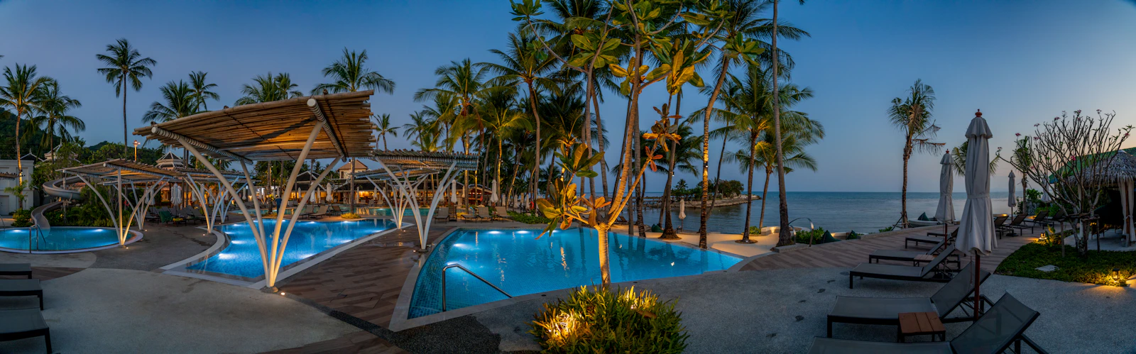 Tropical resort pool surrounded by palm trees in Koh Samui Thailand