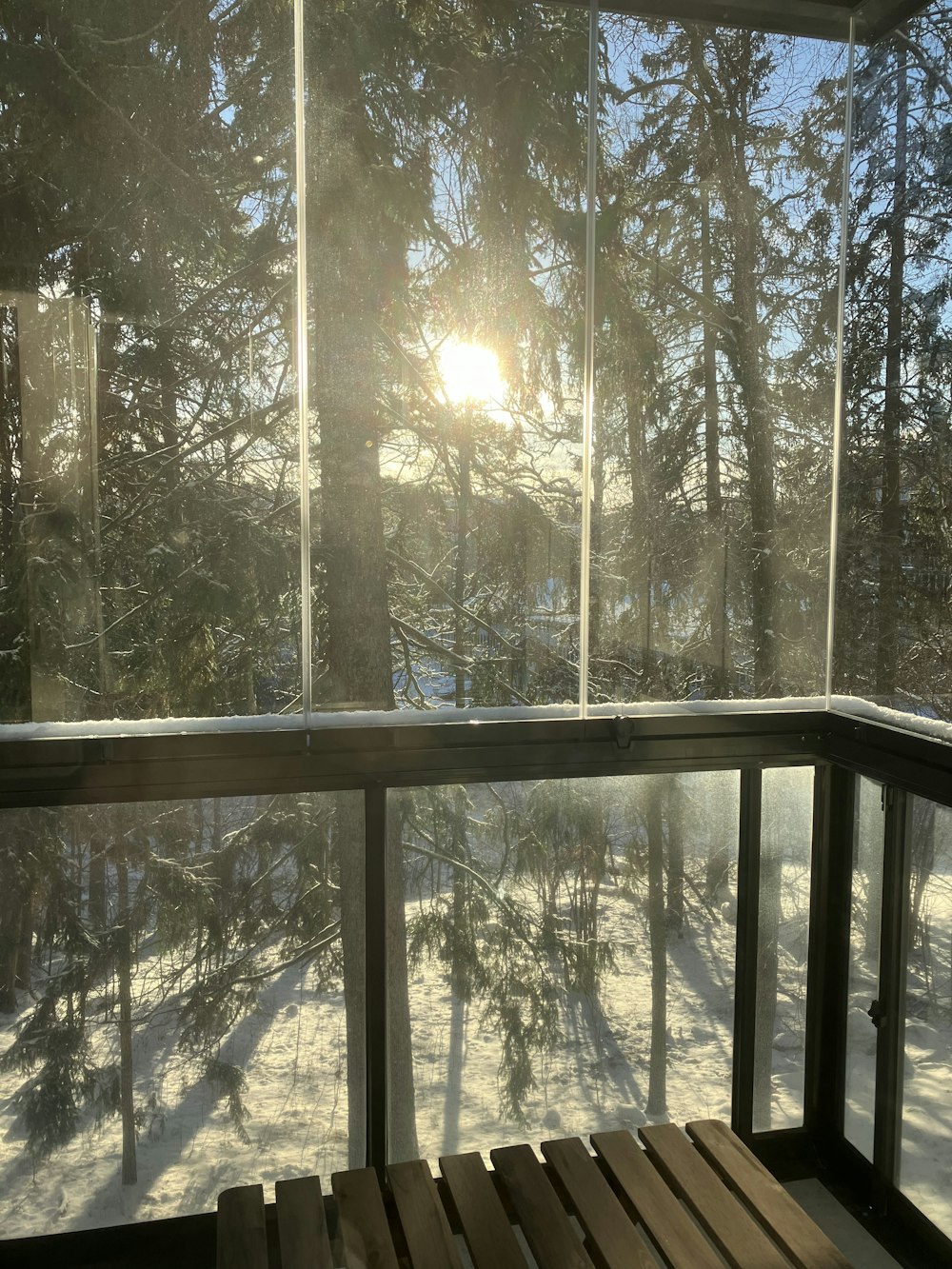 a wooden bench sitting on top of a snow covered ground