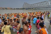 Devotees gathered by the riverbank, immersed in prayer and chanting during the Aarti ceremony.