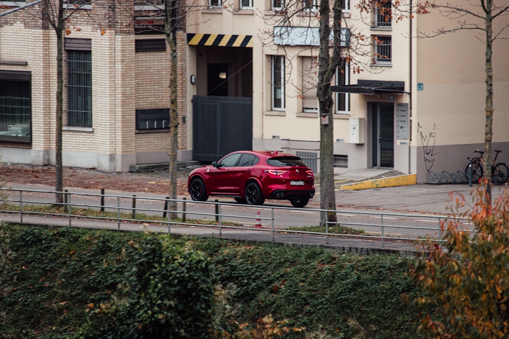 a red car parked on the side of a road