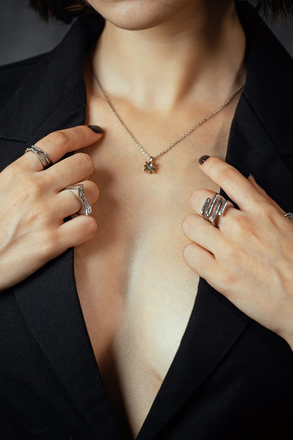 a woman wearing a black shirt and some rings