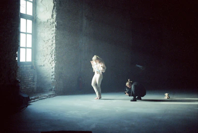 An intimate photo of Miroslava working on a large-scale art installation in a bright studio.