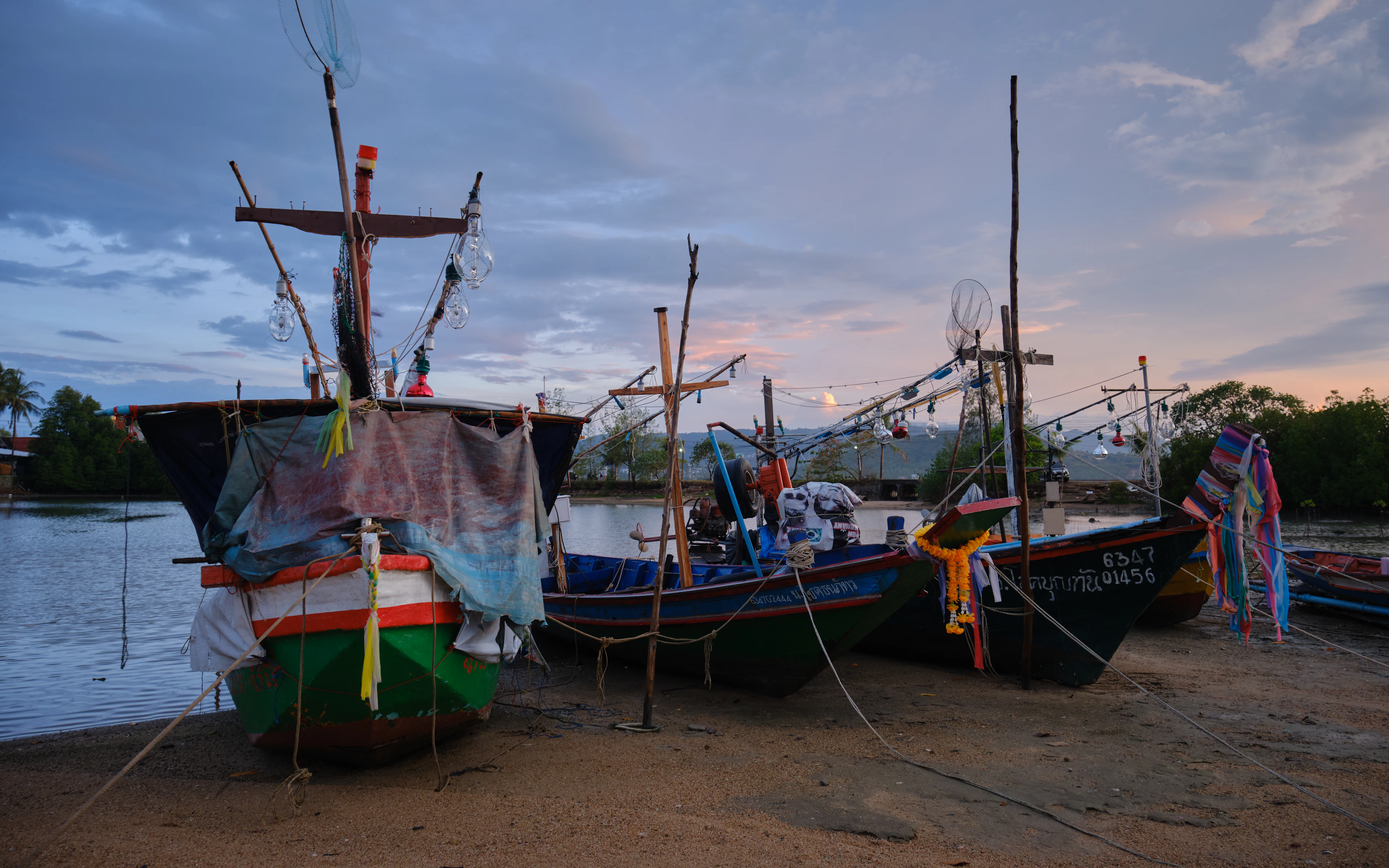 Colourful fishing boats drawn up on the shore at dusk, Koh Samui