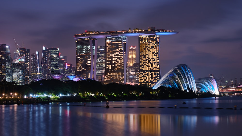 a city skyline at night with the lights on