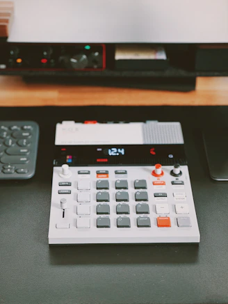 a calculator sitting on top of a table next to a remote control
