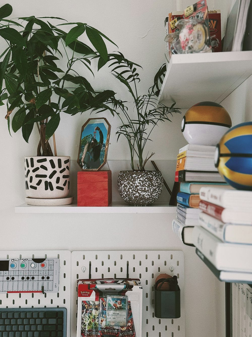 a desk with a keyboard and a plant on top of it