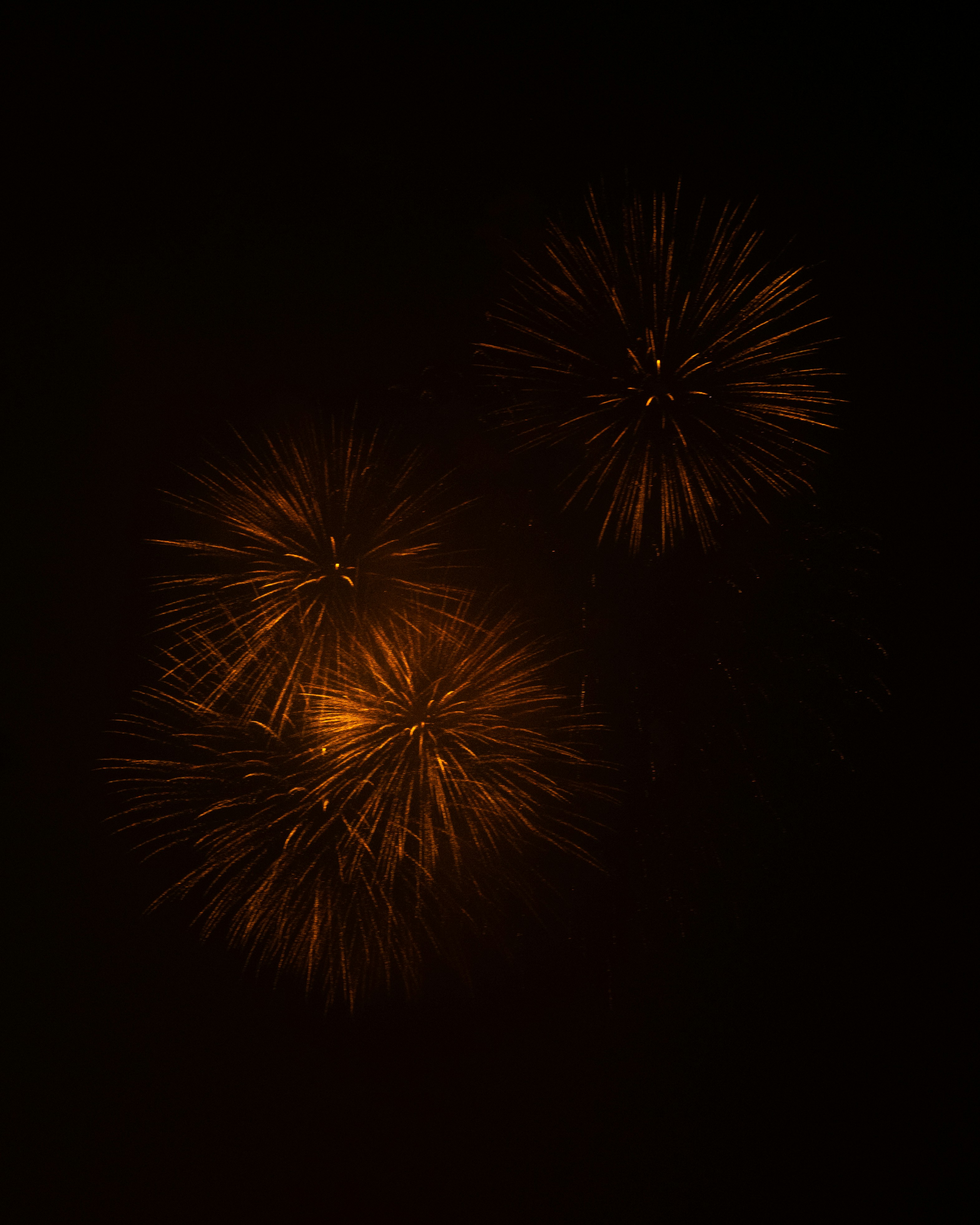 a couple of fireworks are lit up in the night sky