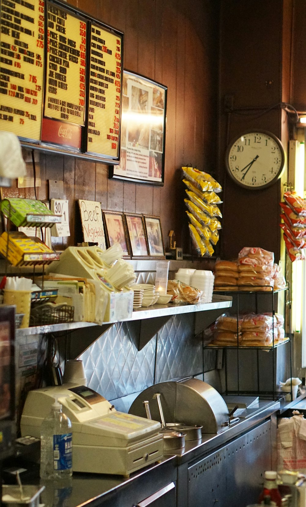 a kitchen with a clock and many items on the counter