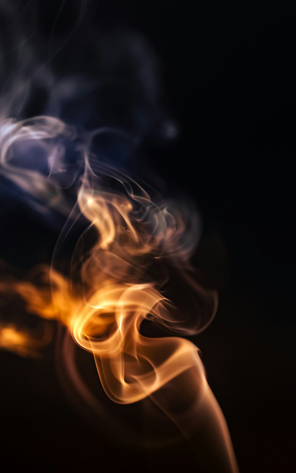 a blurry photo of smoke on a black background