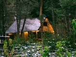 A cozy couple’s retreat cabin nestled in a snowy mountain forest under soft lights.