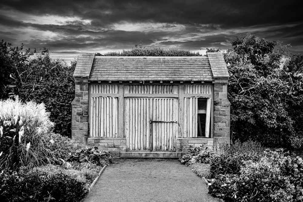 a black and white photo of a garden shed