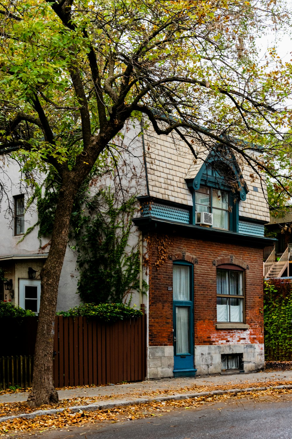 a red brick house with a blue door and window