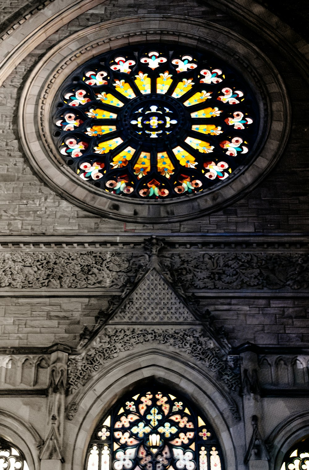 a large stained glass window in a stone building