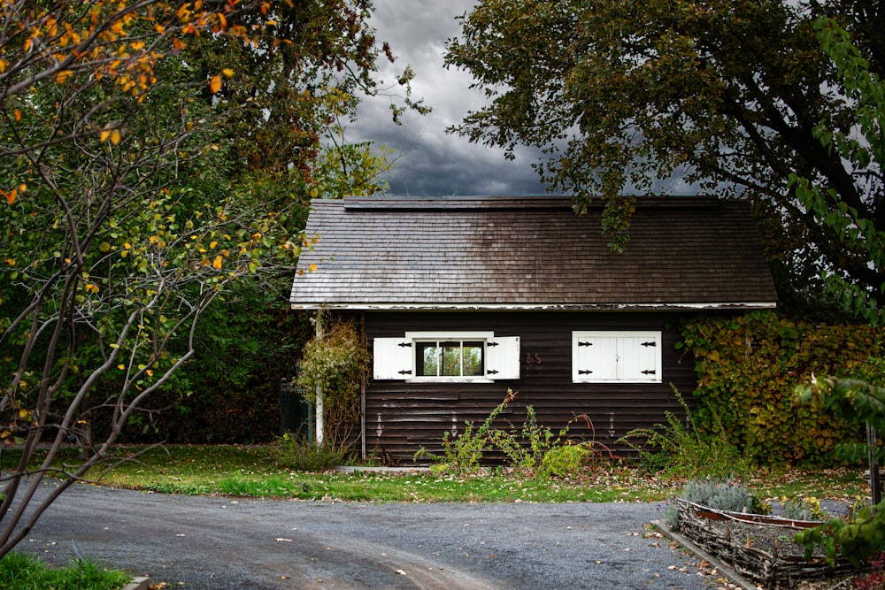 a house with a brown roof and white windows