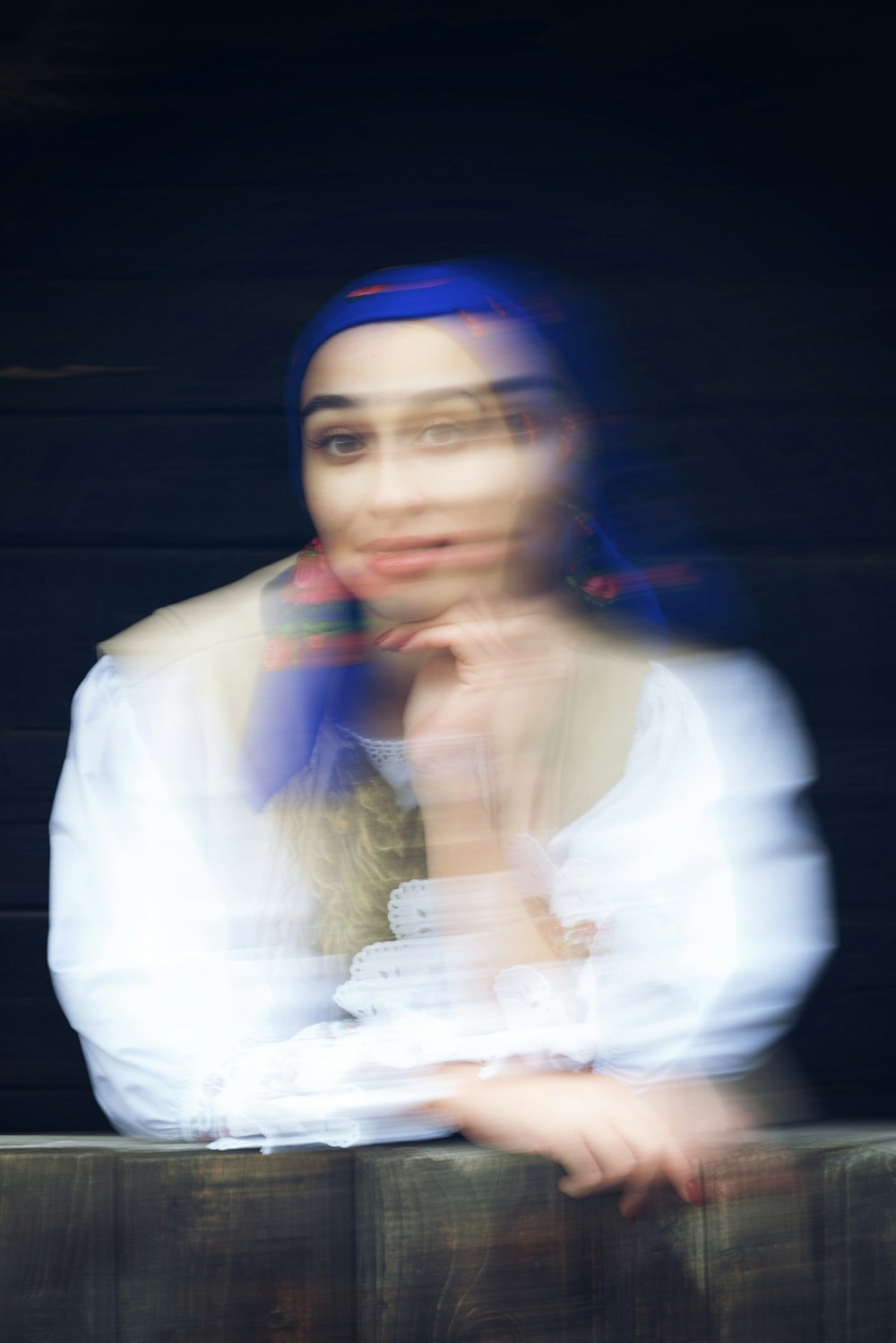 a blurry photo of a woman with blue hair