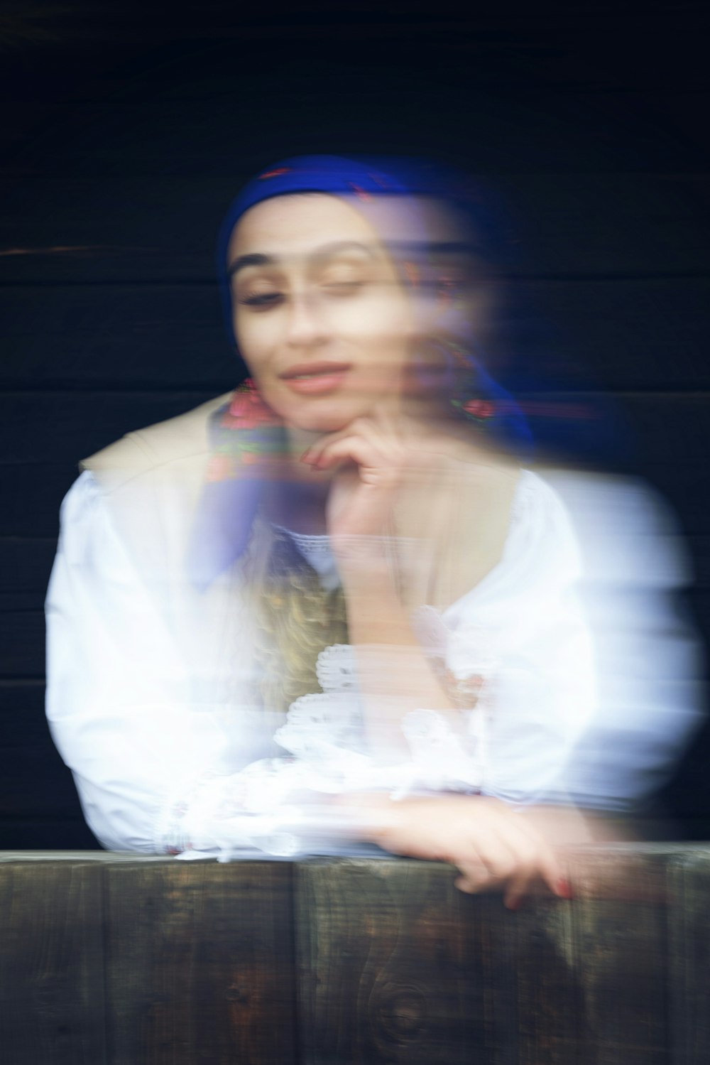 a blurry photo of a woman in a white shirt