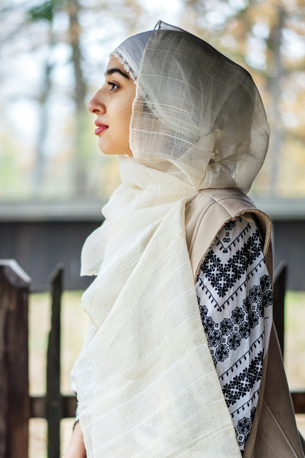a woman wearing a white and black scarf