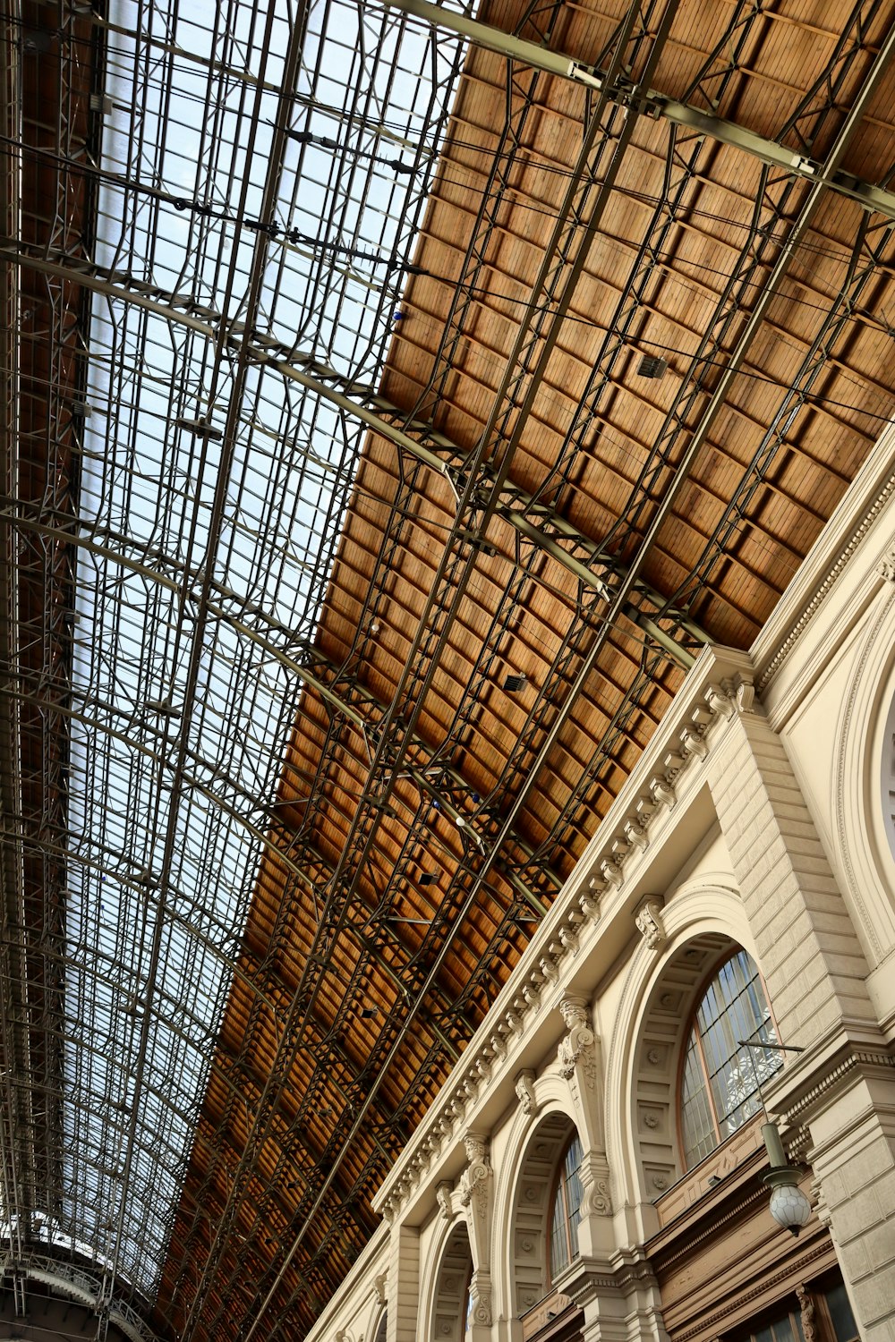 the ceiling of a large building with a clock on it